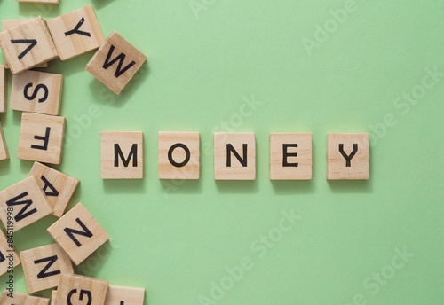 A jumble of wooden letters spell out the word money