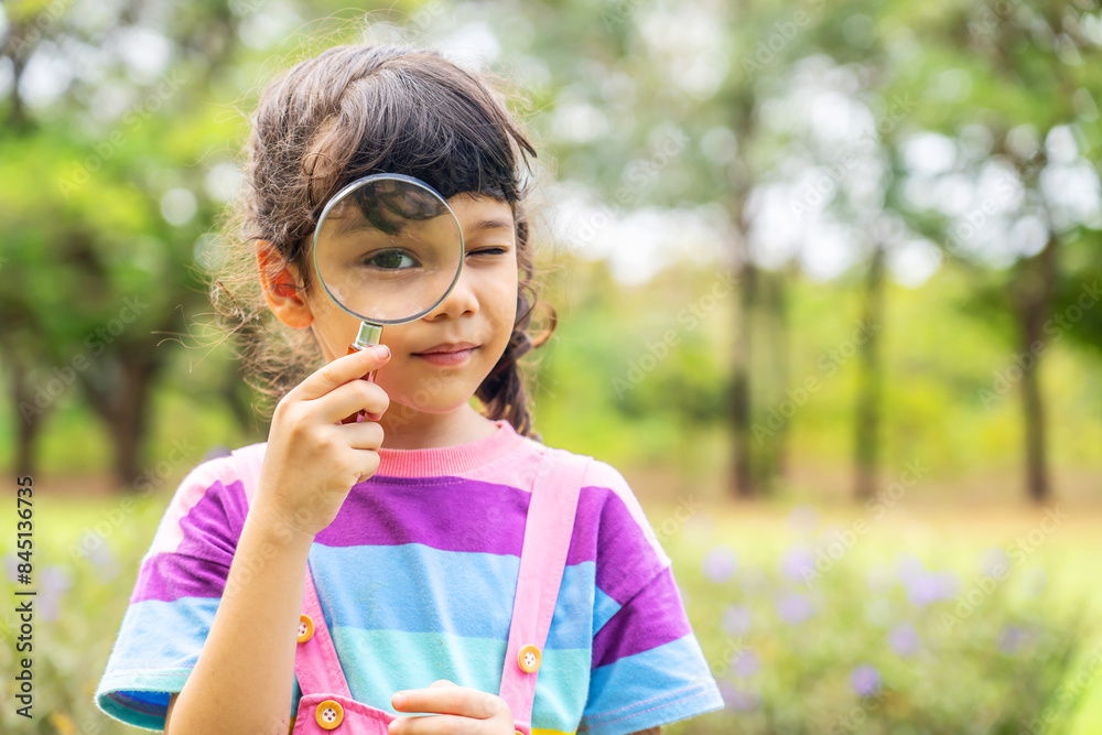 Image of little girl exploring the nature with magnifying glass outdoors, Child playing in the park with magnifying glass. Curious kid exploring nature by magnifier Image of little girl exploring the nature with magnifying glass outdoors, Child playing in the park with magnifying glass. Curious kid exploring nature by magnifier