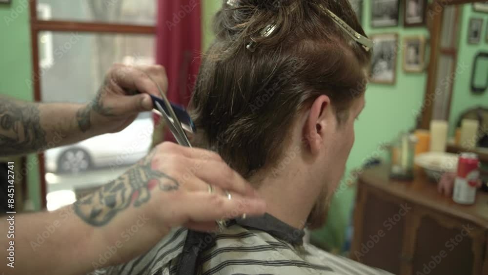 Hairdresser cutting hair of a long hair man Hairdresser cutting hair of a long hair man