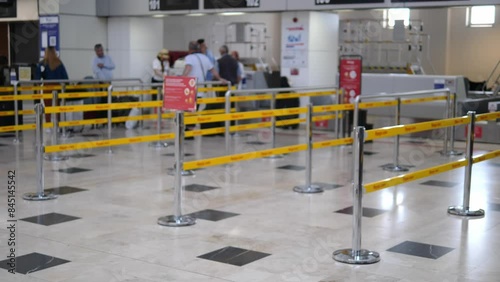At the airport, cordoned-off counters create a boundary, guiding passengers through the terminal. taped areas help organize the flow of people, ensuring smooth navigation within the airport premises.