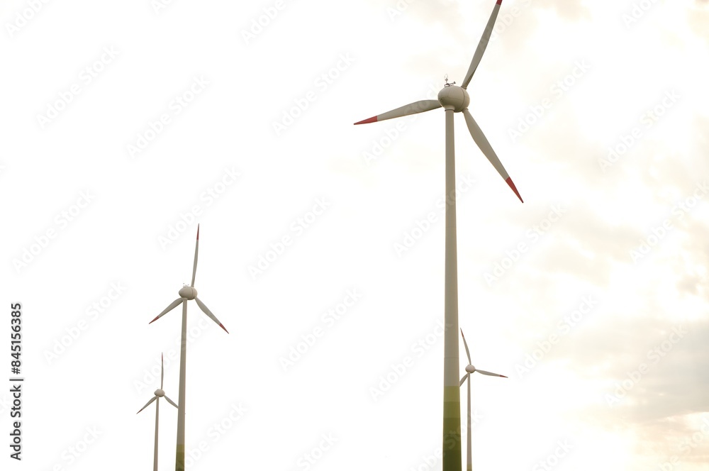 Fototapeta premium Wind turbine in agricultural fields under clear blue sky