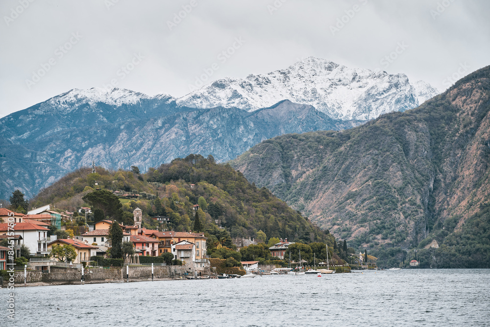 Alpine lakeside town with snow-capped mountains and serene waters Alpine lakeside town with snow-capped mountains and serene waters