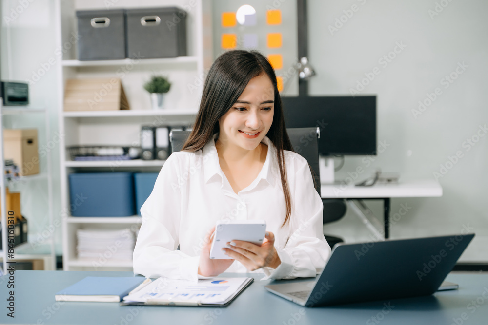 Asian Businesswoman Analyzing Finance on Tablet and Laptop at modern Office Desk tax Asian Businesswoman Analyzing Finance on Tablet and Laptop at modern Office Desk tax