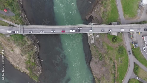 Circling around the old steel bridge in Selfoss at sunset. Cars crossing the bridge photo