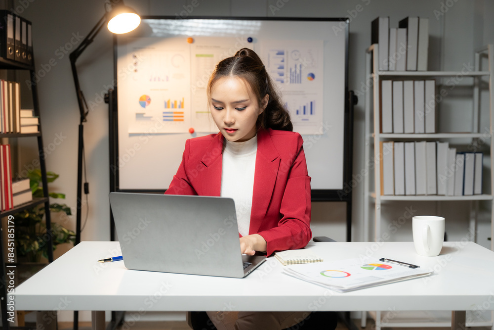 Young woman working using laptop in office Asian businesswoman sitting in her office Young woman working using laptop in office Asian businesswoman sitting in her office