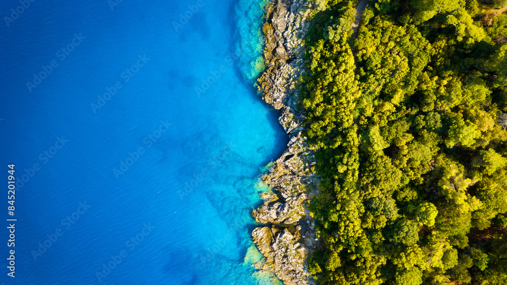 Drone view of the sea coast. Rocky shore and sea water. Vacation and travel. Summer seascape. aerial view. Image for cards, background, wallpaper or design.