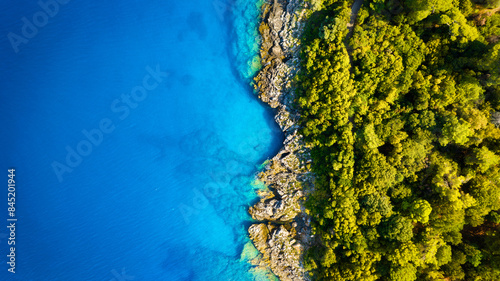 Obraz na płótnie Drone view of the sea coast. Rocky shore and sea water. Vacation and travel. Summer seascape. aerial view. Image for cards, background, wallpaper or design. w salonie