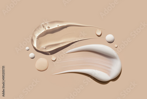 creamy texture of cosmetic samples on a pastel beige background