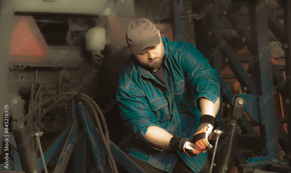 The farmer repairs agricultural machines The farmer repairs agricultural machines