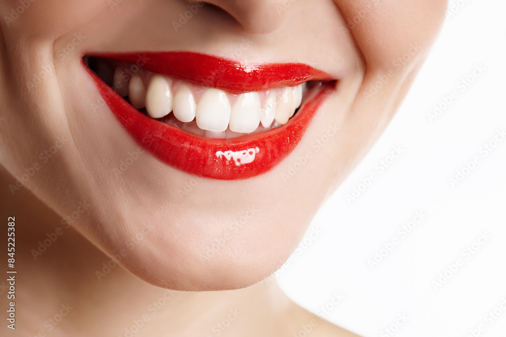 Obraz premium Woman, mouth and happy with red lipstick in studio with makeup, dental and cosmetics treatment with closeup. Person, teeth and dermatology with lip product, cosmetology beauty on white background