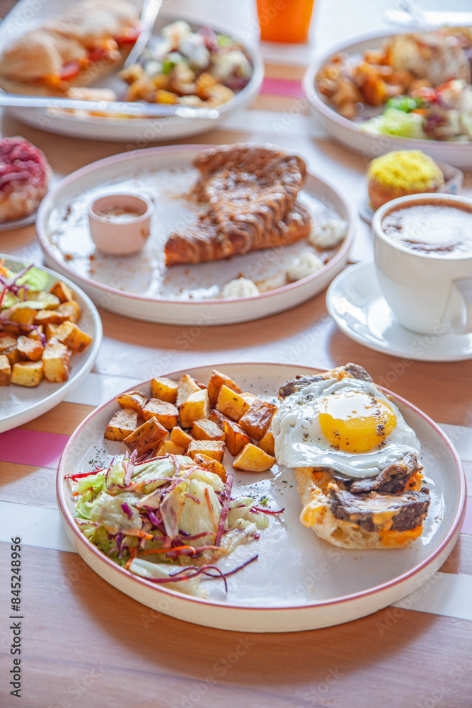 Breakfast table set with assorted dishes and drinks. Breakfast table set with assorted dishes and drinks.