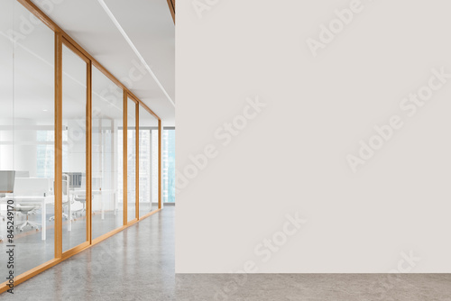 Glass coworking interior with desks in row and panoramic window. Mockup wall