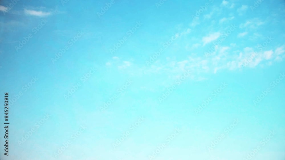 Bright blue sky with small, fast moving clouds. Background with an atmospheric theme in soft, pastel colors. Bright blue sky with small, fast moving clouds. Background with an atmospheric theme in soft, pastel colors.