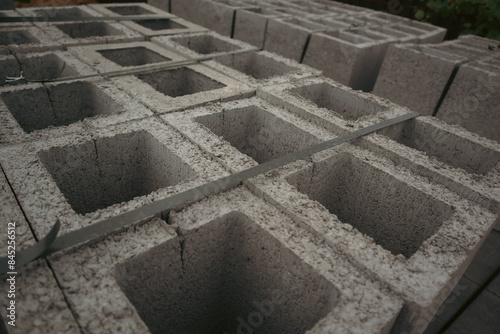 Construction concrete block. Industrial production of building cement pressed materials. Concrete Cinder Blocks. Vibration-pressed hollow building block.