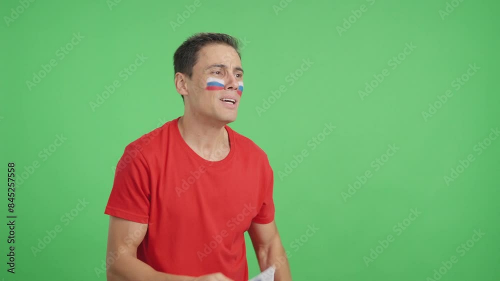 Nervous man cheering for Russia during a match looking away Nervous man cheering for Russia during a match looking away
