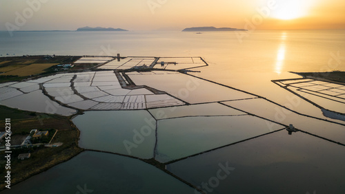 Trapani salt pond Aerial view at sunset with egad islands at distance in Mediterranean Sea  photo