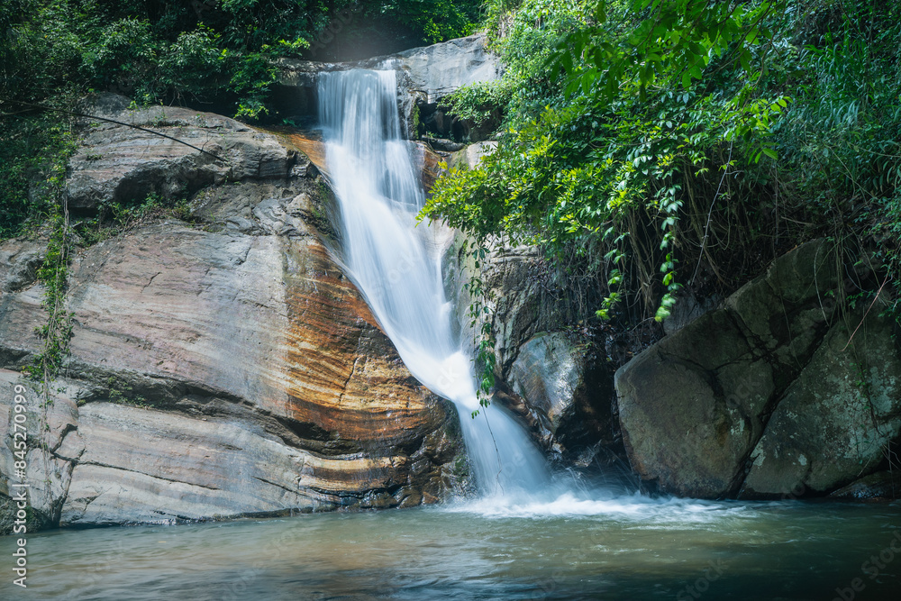 Naklejka premium Smooth small waterfall in secret tropical forest Sri Lanka in long exposure