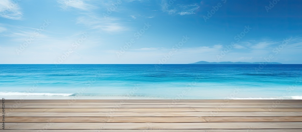 Fototapeta premium A scenic summer tropical sea with a spacious wooden table set against a clear blue sunny sky A versatile background template allowing ample space for your product