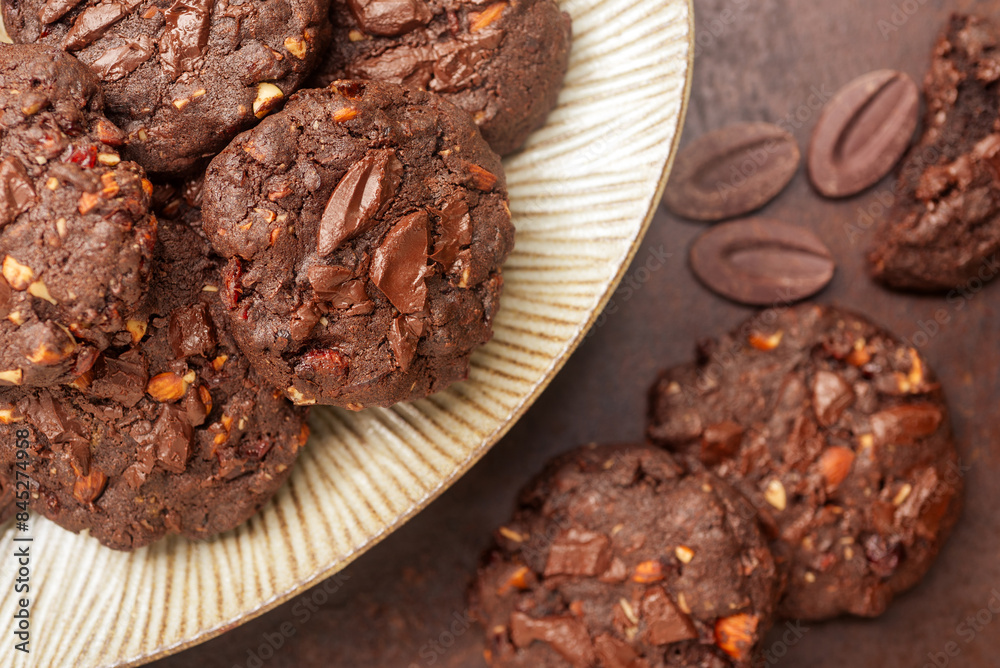 double chocolate cookies in ceramic plate on rusty background. double chocolate cookies in ceramic plate on rusty background.