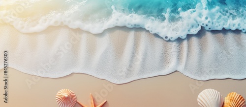 Fototapeta Naklejka Na Ścianę i Meble -  Flat lay view of a creative sand wave layout on a summer beach background The image features shells a sea star and a blurred palm tree with abundant copy space
