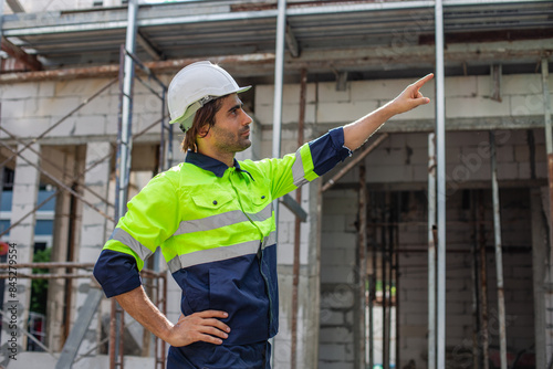 portrait of man engineer builder house construction wear helmet and safety uniform. male architect standing at home construction. foreman in workplace.