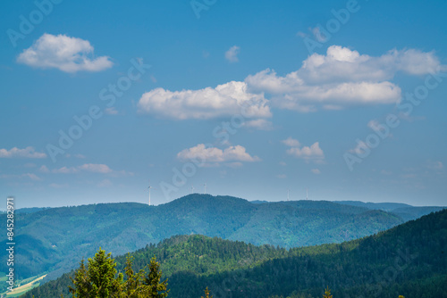 Germany, Far beautiful panorama view above green woodland of black forest schwarzwald nature landscape with many wind turbines generating electricity