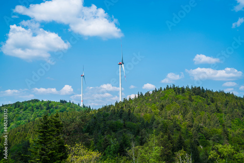 Obraz na płótnie Germany, Renewable energy created by two wind turbines in black forest schwarzwald nature landscape surrounded by trees w salonie