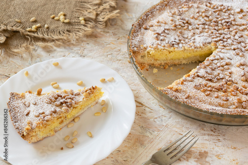Homemade Grandma's Cake with shortcrust pastry, custard and pine nuts, traditional Italian Custard Pie