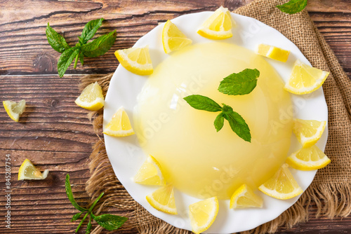 Traditional Sicilian Lemon Pudding with Lemon juice, corn starch and sugar, on wooden background. Gelo di Limone, Lemon Gelo