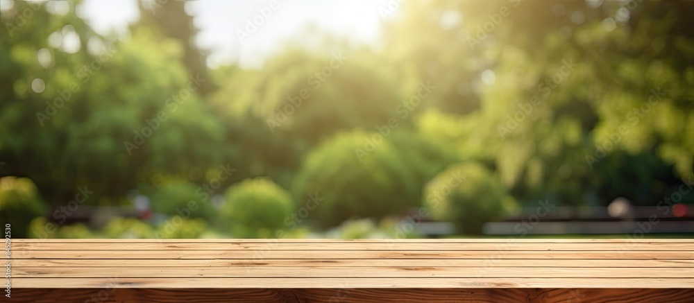 The wooden table is empty with a background of a blurred outdoor garden offering a spacious area for text marketing promotions Copy space image The wooden table is empty with a background of a blurred outdoor garden offering a spacious area for text marketing promotions Copy space image