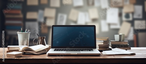 Wallpaper Mural A modern laptop complete with office equipment sits on a table Its screen is blank providing ample copy space for your internet content There are also paper documents and diagrams scattered on the wo Torontodigital.ca