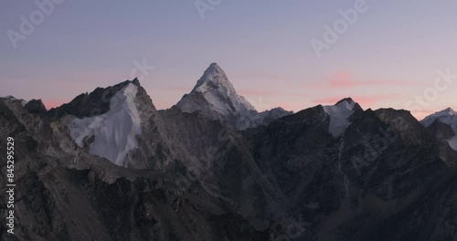 Drone captures Ama Dablam at sunset from Everest Base Camp, Nepal, with red, pink, and blue skies. Magical evening with breathtaking views. High-resolution, vibrant footage photo