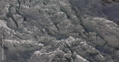 Drone captures ice fall and mountains at Khumbu Glacier, Everest Base Camp, Nepal. Melting glacier due to global warming on a sunny day with clear sky. High-resolution, stunning view.