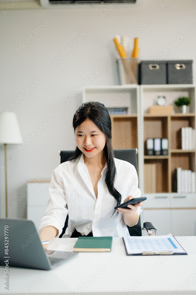 businesswoman working at office with laptop, tablet and taking notes on the paper.. businesswoman working at office with laptop, tablet and taking notes on the paper..