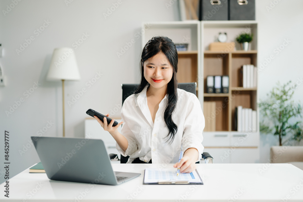 businesswoman working at office with laptop, tablet and taking notes on the paper.. businesswoman working at office with laptop, tablet and taking notes on the paper..