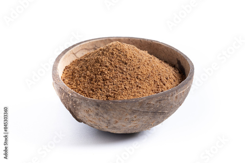 Coconut palm sugar in coconut bowl isolated on white background.