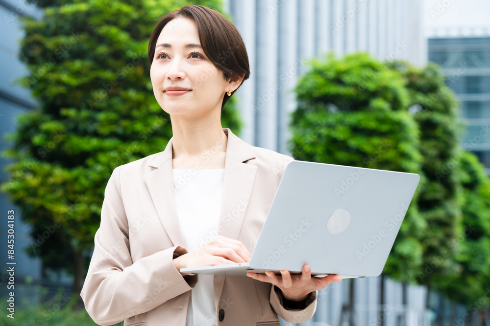 ノートパソコンを操作している若い女性 ビジネスイメージ ノートパソコンを操作している若い女性 ビジネスイメージ