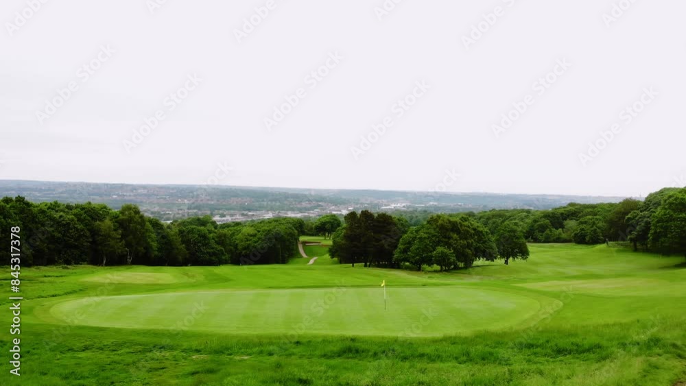Golf course playing fields in England drone aerial wide shot Golf course playing fields in England drone aerial wide shot