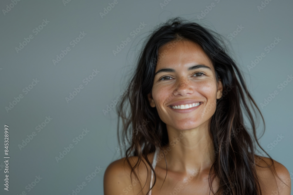 A close up portrait of a woman with a subtle smile A close up portrait of a woman with a subtle smile