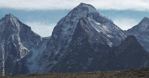 Extended drone footage of a male hiker on the Everest Base Camp trek in Nepal, reveling in the majestic views of towering mountains. High-resolution, scenic, breathtaking photo