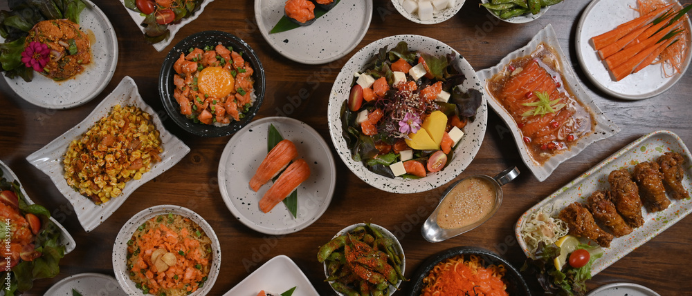 Top view of various traditional Japanese food dishes on wooden table Top view of various traditional Japanese food dishes on wooden table