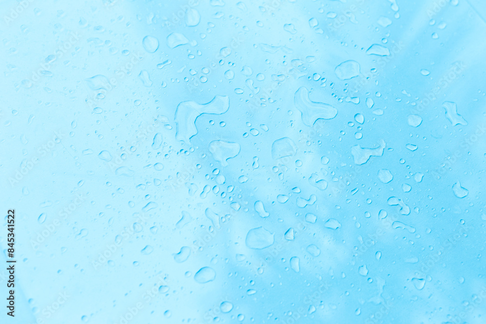 Water drop on blue background, water splash on clear blue background Water drop on blue background, water splash on clear blue background