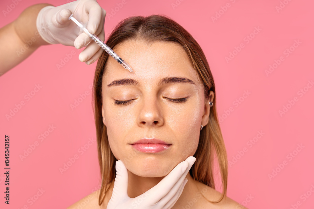 A woman is receiving a facial treatment at a salon to achieve a glowing and youthful look A woman is receiving a facial treatment at a salon to achieve a glowing and youthful look