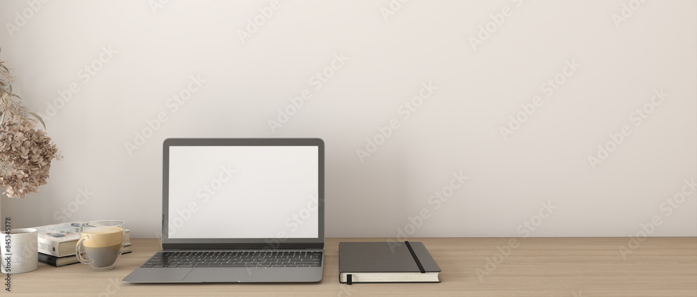 A laptop and a notebook sit on a wooden desk A laptop and a notebook sit on a wooden desk