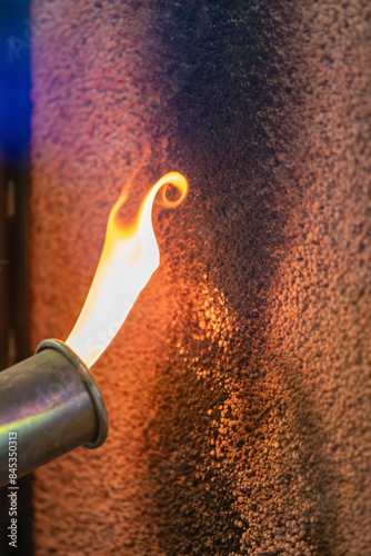 Foto Close up of a flame torch testing flame retardant material, demonstrating fire r