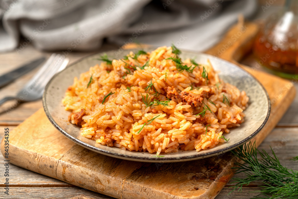 Rice with minced beef in tomato sauce in a plate closeup