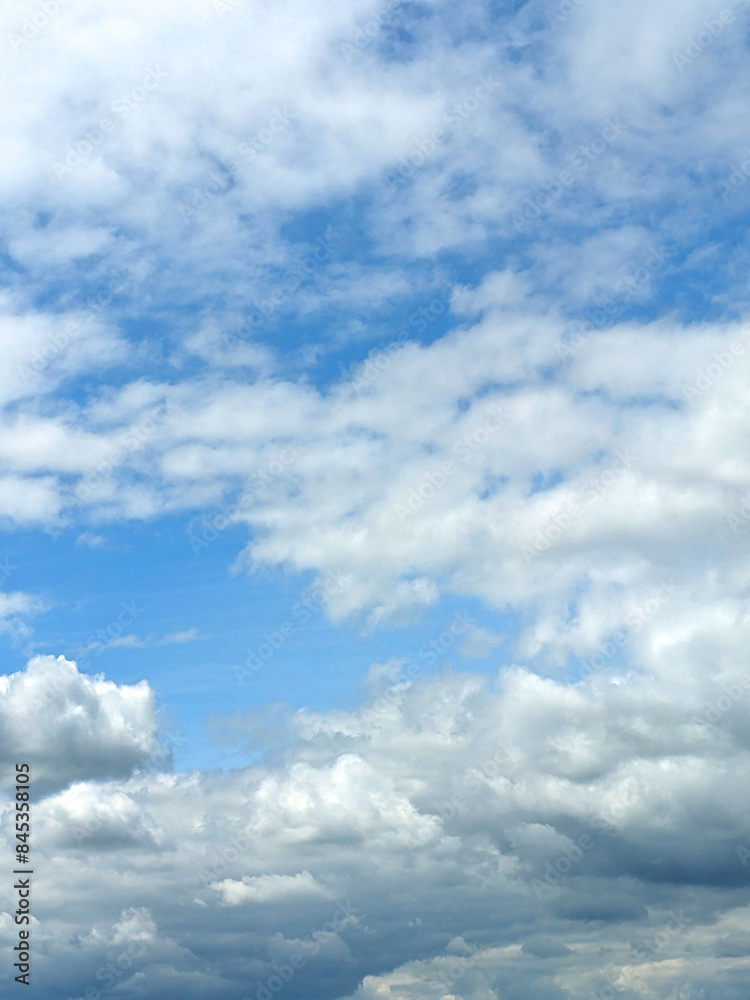 Fluffy White Clouds in a Blue Sky as A Skyscape Background Fluffy White Clouds in a Blue Sky as A Skyscape Background