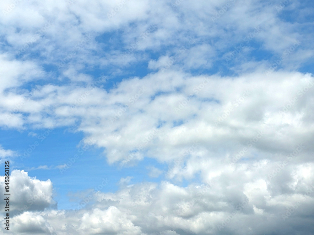 Fluffy White Clouds in a Blue Sky as A Skyscape Background Fluffy White Clouds in a Blue Sky as A Skyscape Background