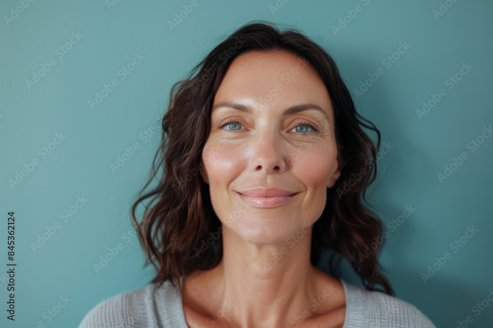 A close up portrait of a woman with a subtle smile A close up portrait of a woman with a subtle smile