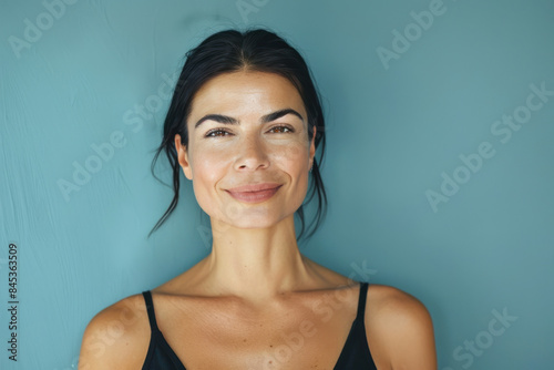 A close up portrait of a woman with a subtle smile
